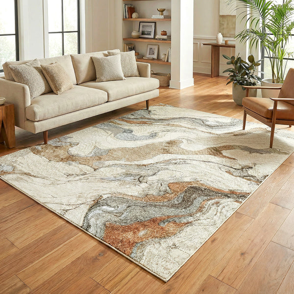 Large abstract patterned rug in tan, beige, gray, and rust tones with a modern marble effect design on a hardwood floor in a .