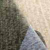 Close-up of Tanami 336 rug showing textured weave with overlapping beige, gray, and blue abstract color blocks.