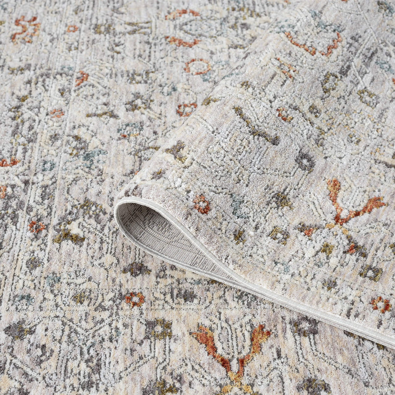 Close-up of a textured rug with a pattern and a white rug border.