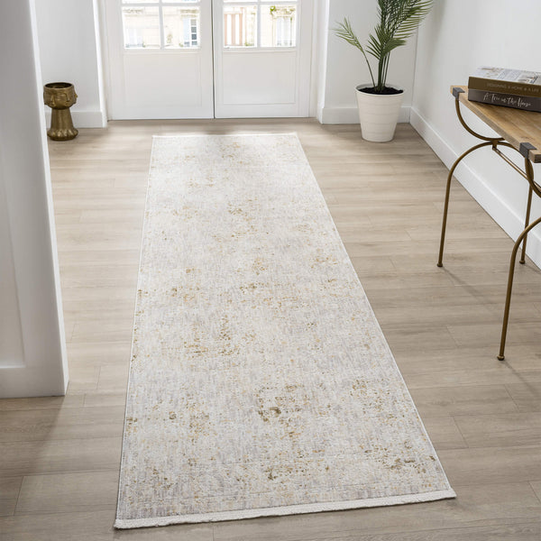 Long rectangular runner rug on a wooden floor with a plant and side table in the background.