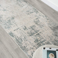 Patterned area rug on a wooden floor with a chair partially visible.