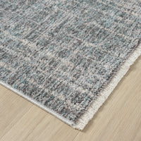 Close-up of a textured gray rug on a wooden floor