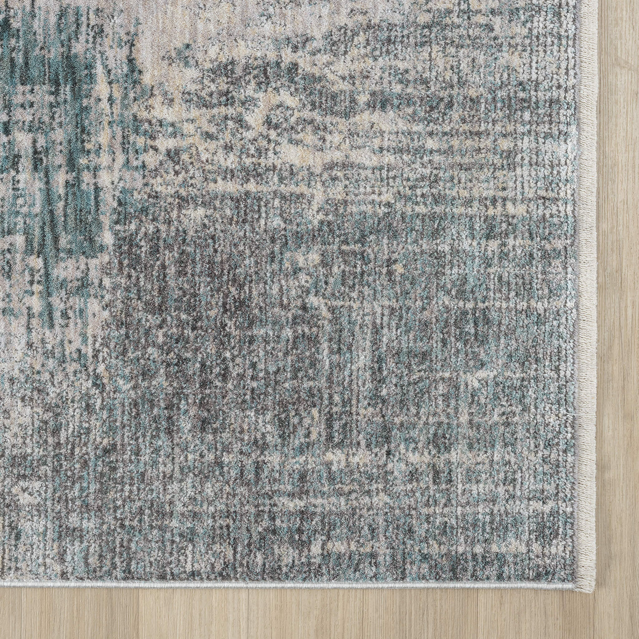 Textured area rug with geometric pattern on a wooden floor