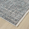 Close-up of a textured gray rug on a wooden floor