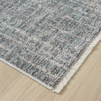 Close-up of a textured gray rug on a wooden floor