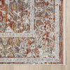 Close-up of a patterned rug with earthy tones on a wooden floor.