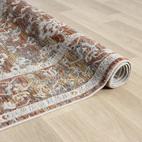 Roll of patterned rug on a wooden floor