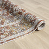Roll of patterned rug on a wooden floor