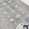 Blue floral patterned transitional runner rug with subtle beige and cream accents on wood floor.