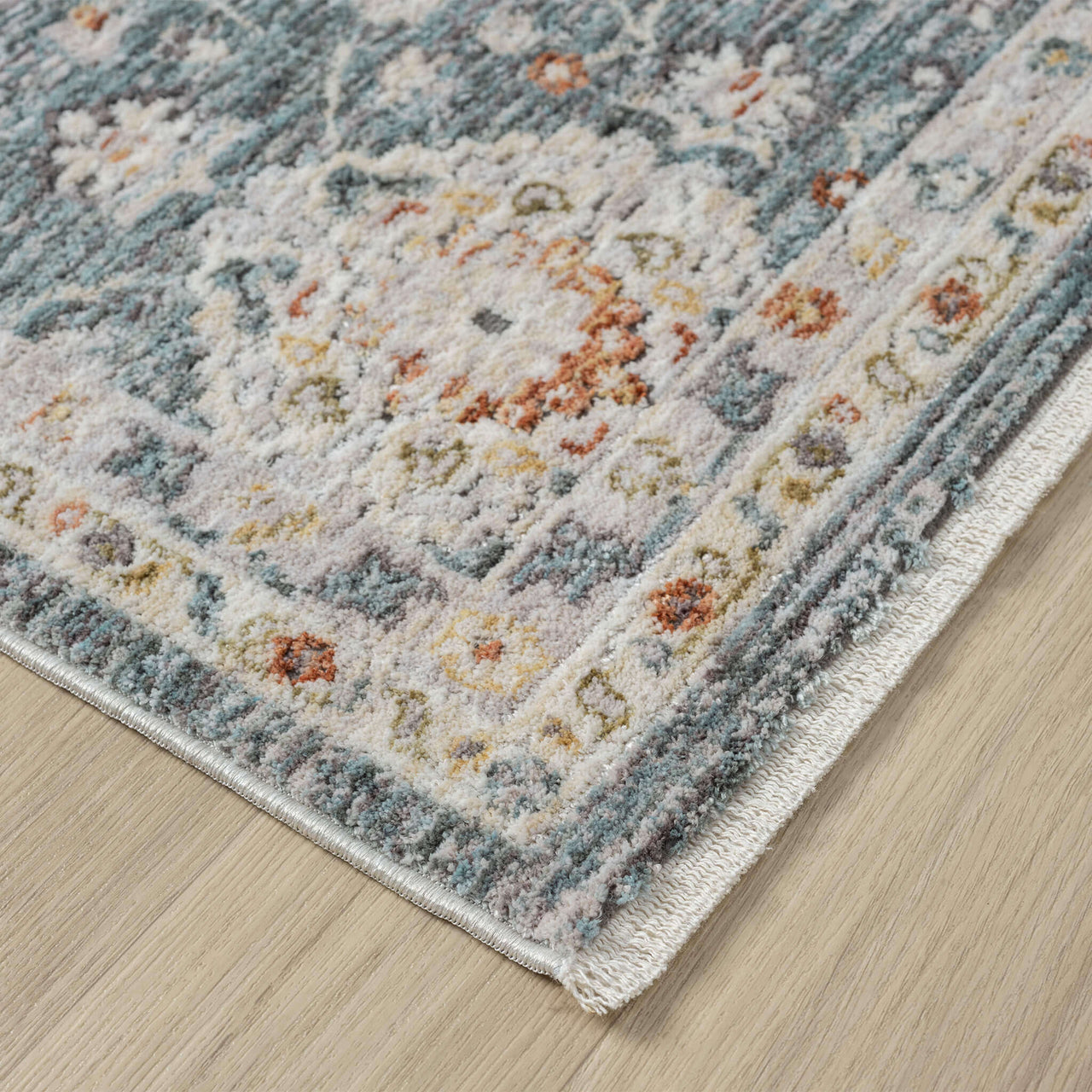 Blue transitional runner rug with intricate floral pattern and subtle beige and rust accents.