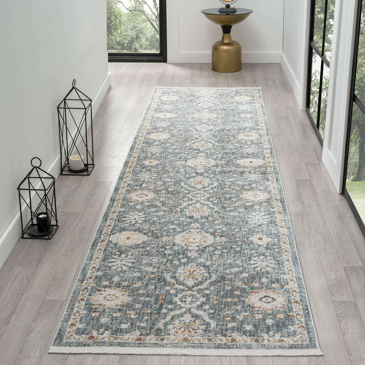 Blue runner rug with intricate floral and geometric patterns in beige and gray tones.