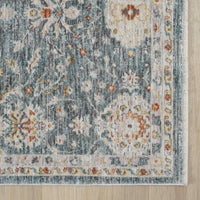 Blue transitional rug with intricate floral pattern and beige border.