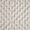 Grey geometric patterned rug with raised textured pile and soft polyester fibers.