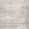 Grey modern rug with subtle geometric abstract pattern and textured pile.