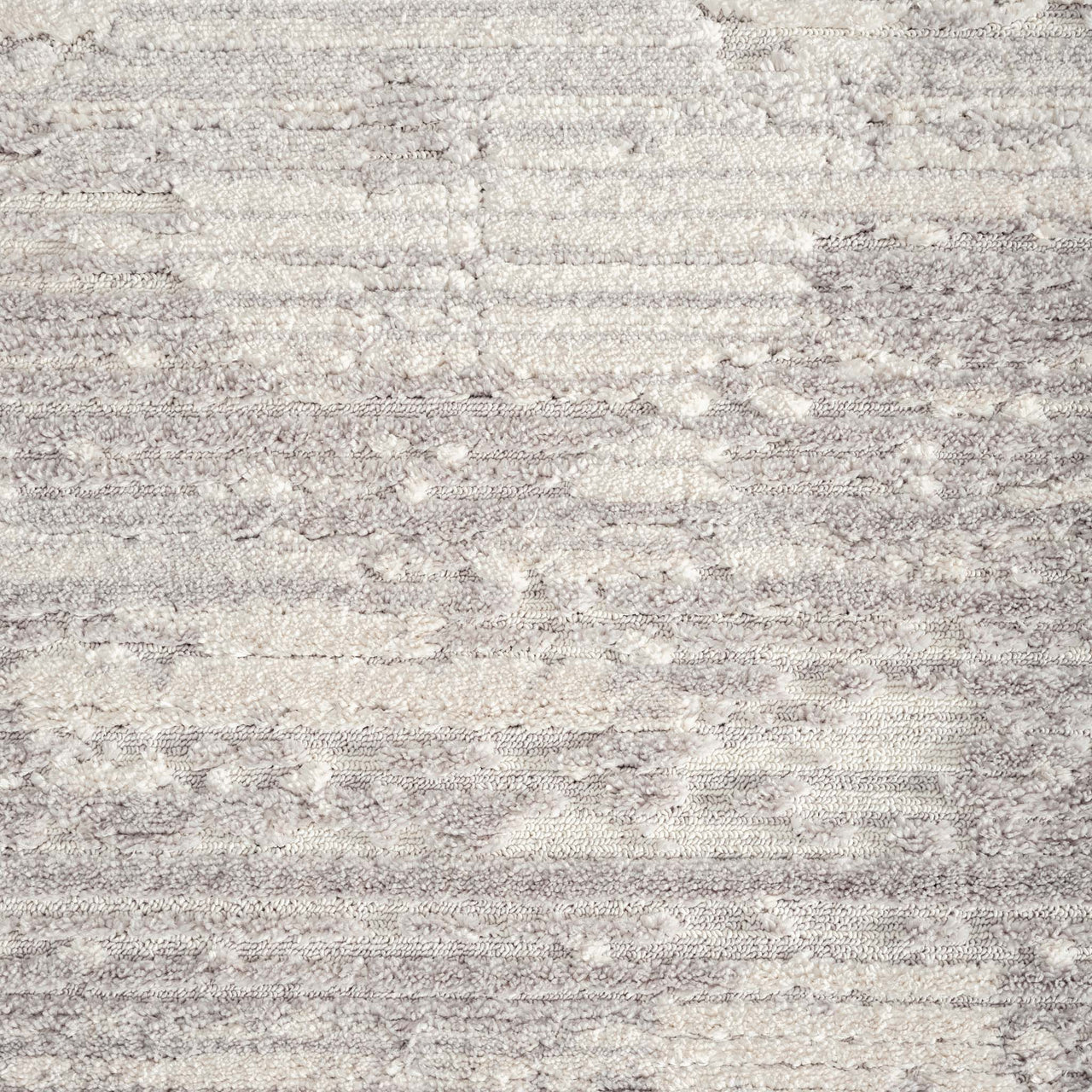 Grey modern rug with subtle geometric abstract pattern and textured pile.