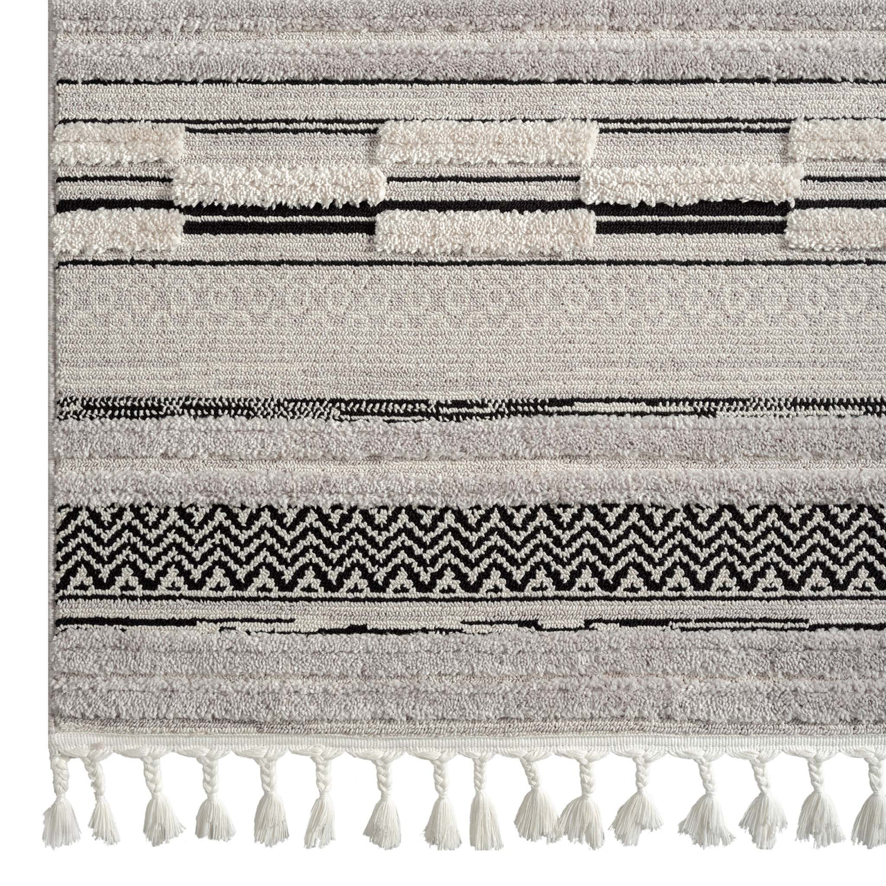 Grey rug with layered geometric patterns and textured pile, featuring tassels on one edge.