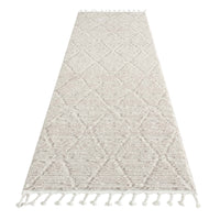 Beige runner rug with geometric diamond pattern, textured pile, and tasseled edges.