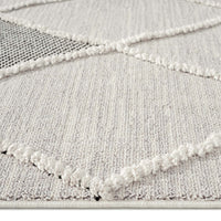Grey runner rug with raised diamond geometric textured pattern and a soft woven pile.