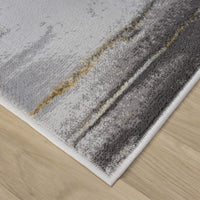 Grey runner rug with abstract textured pattern in muted yellow and dark grey tones, white finished edge.