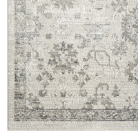 Cream and grey patterned runner rug with distressed vintage style and geometric motifs.