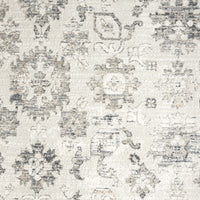 Modern cream and grey patterned runner rug with distressed geometric motifs.