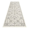 Modern cream and grey runner rug with intricate floral and geometric pattern and fringed edges.