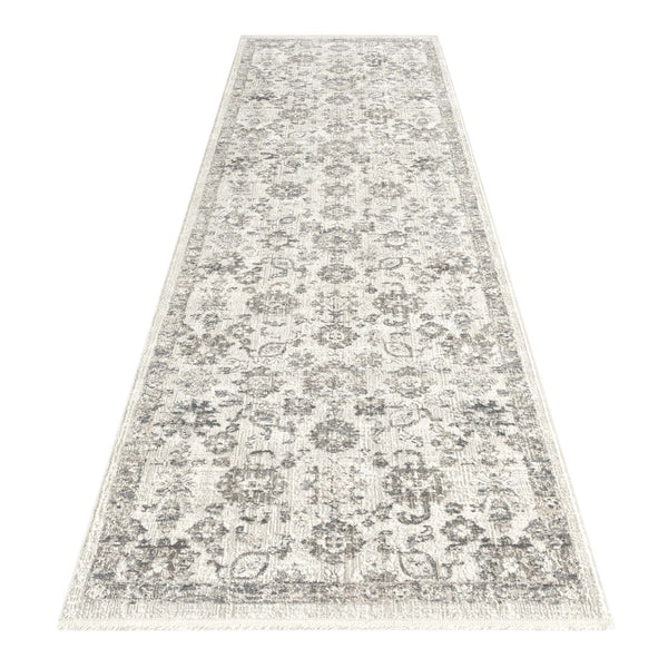 Modern cream and grey runner rug with intricate floral and geometric pattern and fringed edges.