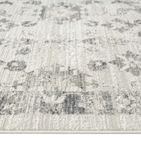 Modern cream and grey patterned runner rug with subtle distressed floral motifs and textured weave.