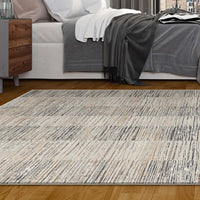 Modern neutral-toned rug with textured linear pattern on hardwood floor beside bed with gray and white bedding.