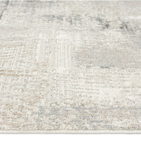 Modern runner rug with abstract neutral pattern in shades of beige, cream, and light gray.