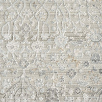 Light neutral rug with subtle floral patterns and textured woven design.