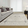 Light neutral floral patterned rug with subtle beige and gray tones in a modern living room setting.