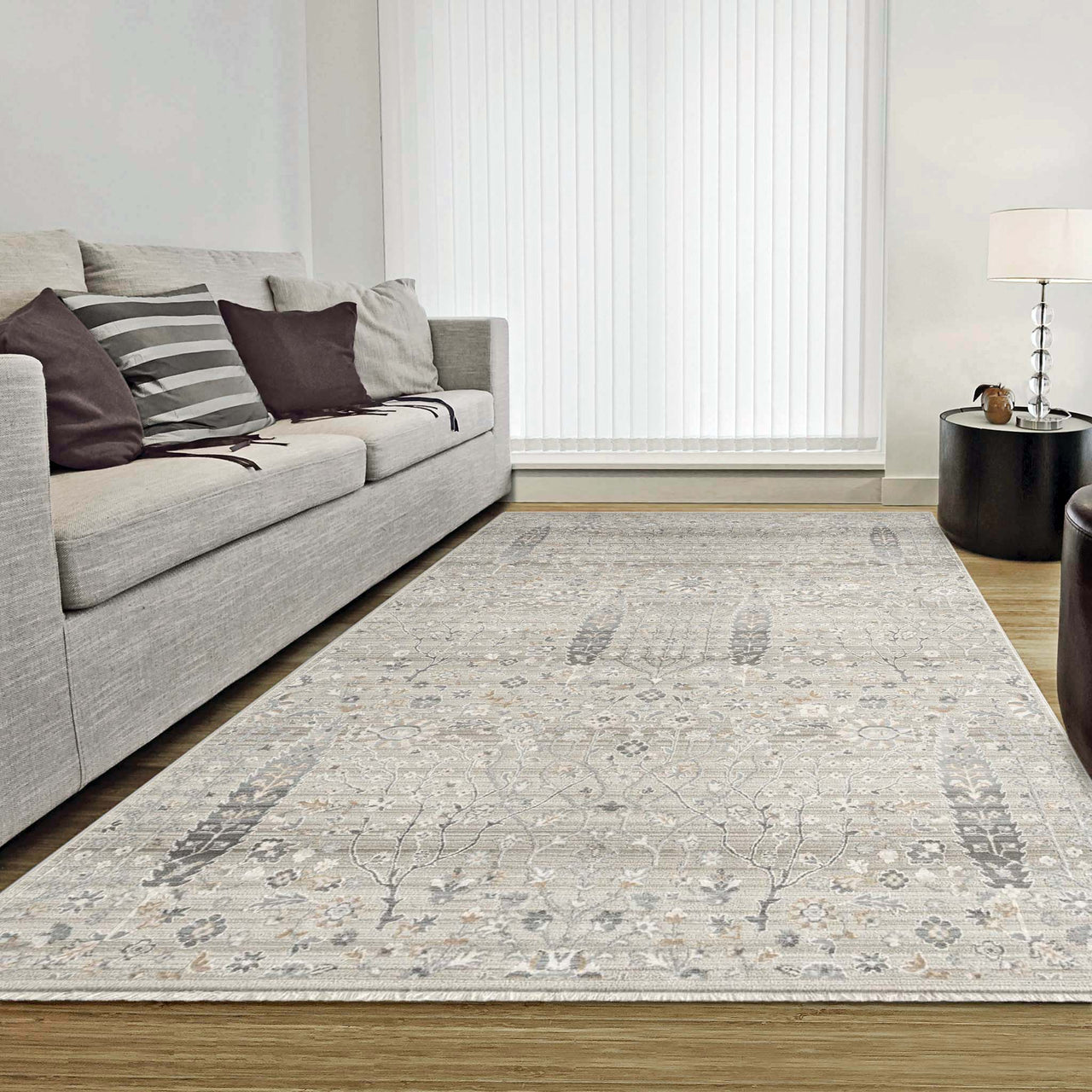 Light neutral floral patterned rug with subtle beige and gray tones in a modern living room setting.