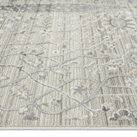 Neutral-toned runner rug with delicate floral and geometric patterns in beige and gray tones.