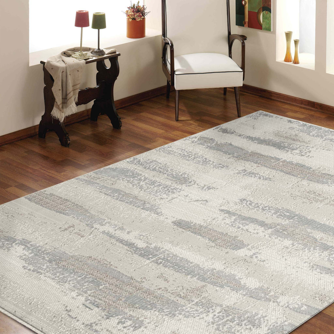 Modern neutral rug with soft grey and beige abstract patterns on a plush surface.