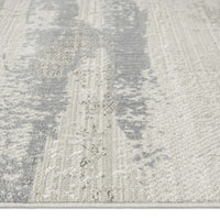 Neutral-toned runner rug with textured modern abstract pattern in soft gray and beige hues.