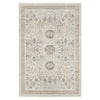 Light neutral rug with intricate modern geometric and floral patterns in beige and gray tones.