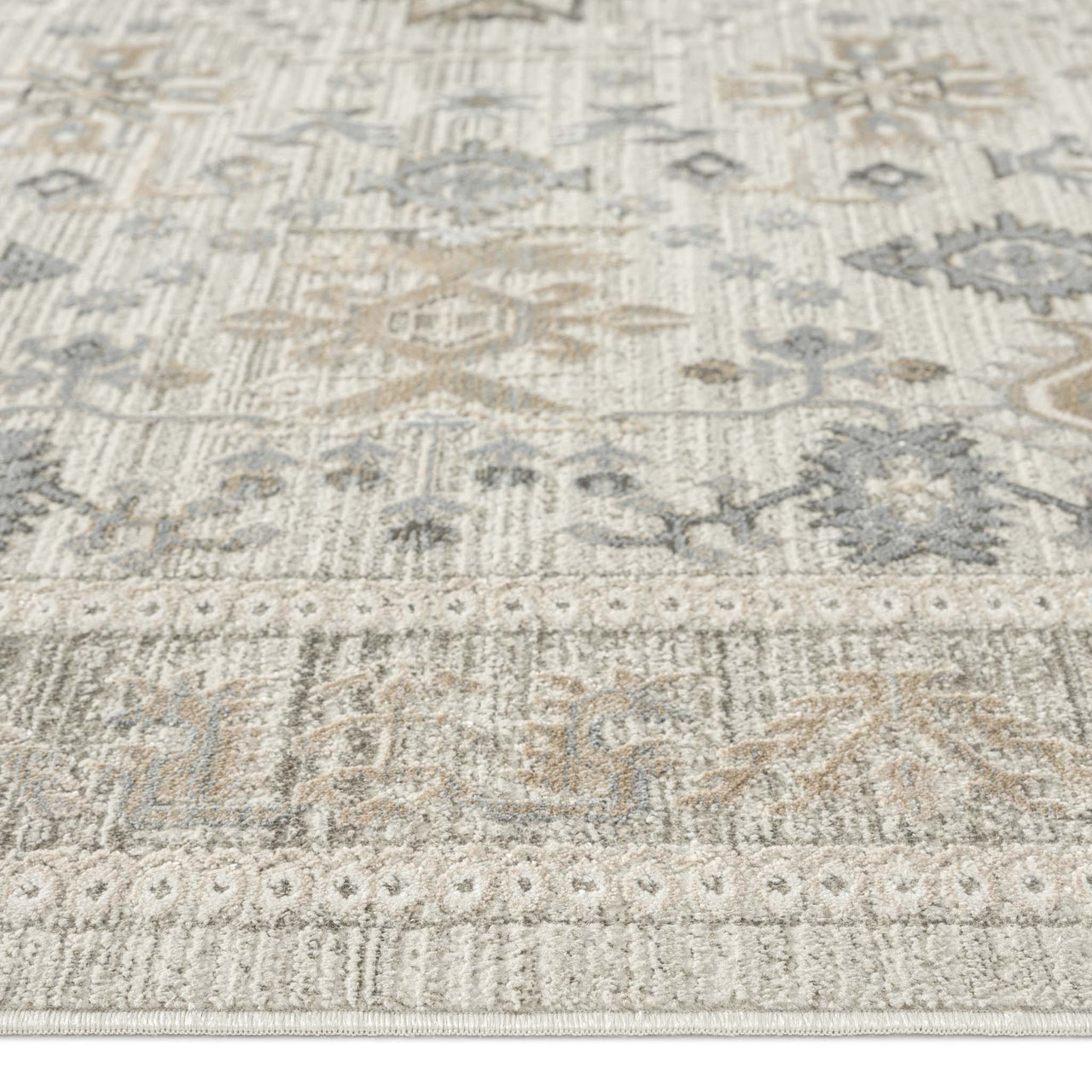 Light neutral rug with subtle geometric and floral motifs in beige and grey tones.