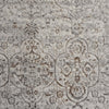 Grey beige rug with intricate faded floral and geometric pattern in a modern vintage style.