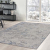 Grey patterned modern rug with subtle abstract design on light wood floor in bright room.