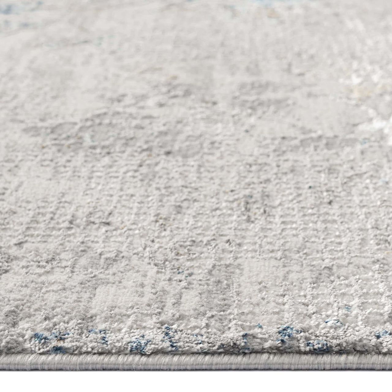 Grey patterned modern rug with subtle texture and low pile, close-up detail.
