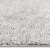 Grey patterned modern rug with subtle texture and low pile, close-up detail.