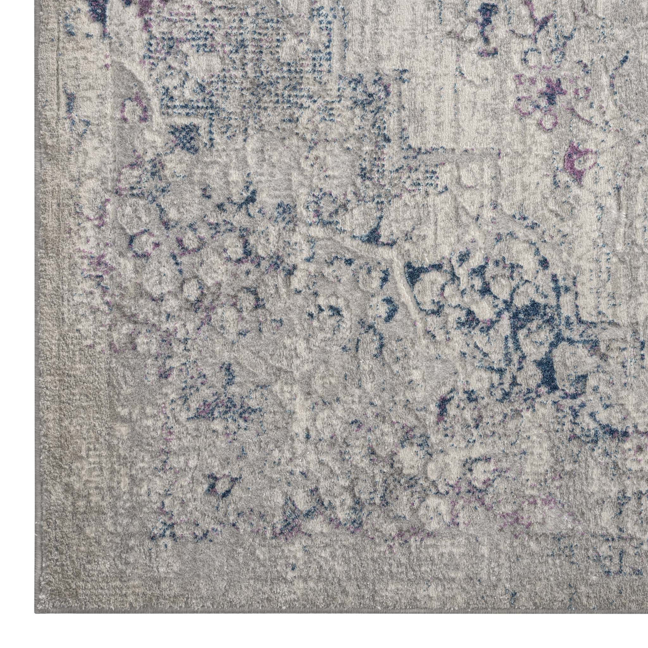 Grey-blue modern rug with intricate faded floral and geometric patterns, low-sheen polyester texture.