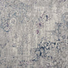 Grey blue modern rug with subtle distressed pattern and hints of soft purple and navy tones.