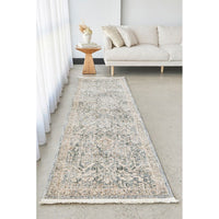 Long rectangular rug in a living room setting with a sofa and side table.