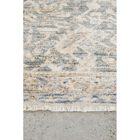 Close-up of a textured rug with a geometric pattern on a concrete floor.