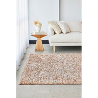 Living room with a beige rug, white sofa, and wooden side table.