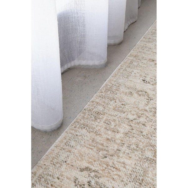 Beige and cream transitional medallion rug with subtle multi-colored pattern and textured polyester weave.
