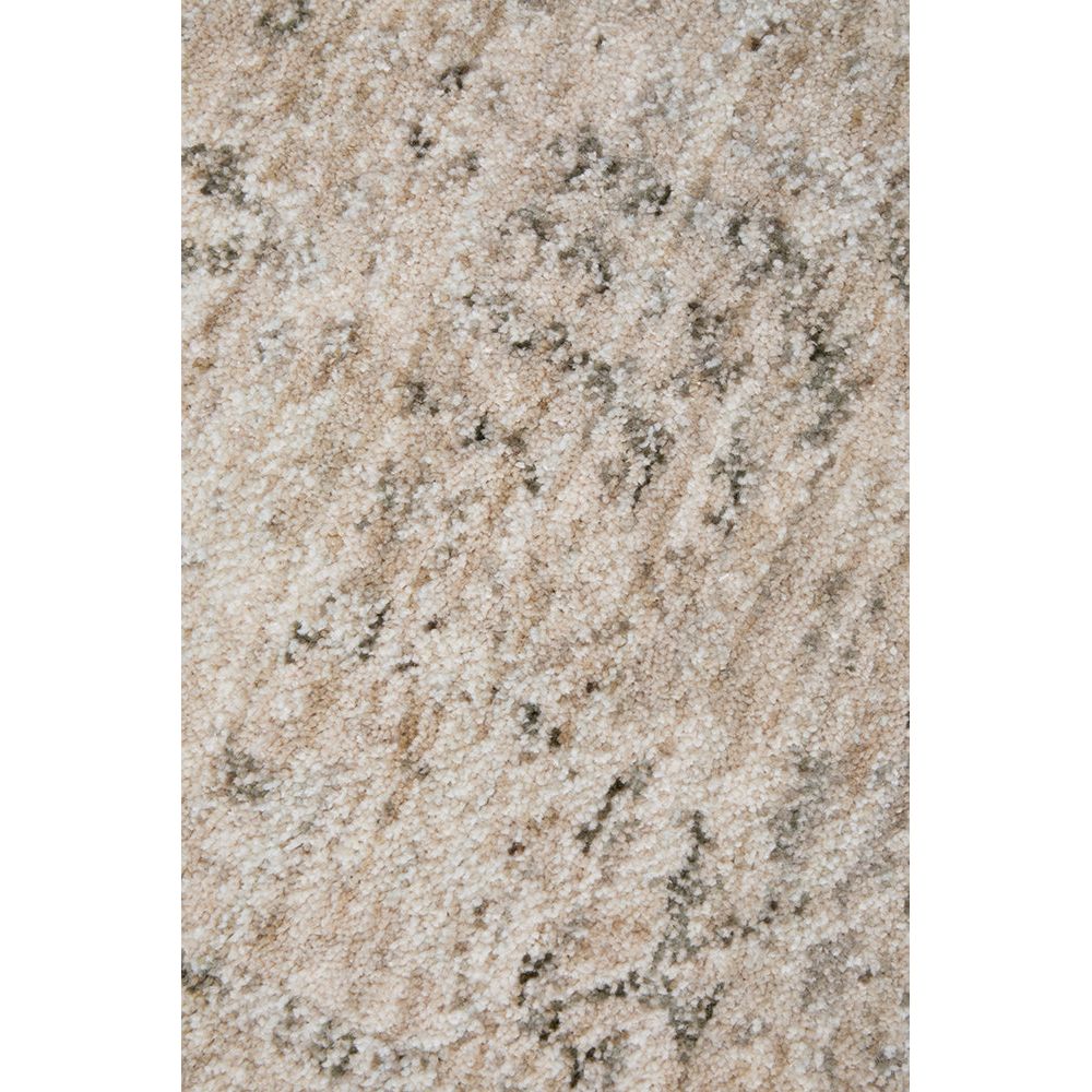 Close-up of a textured beige surface with black specks