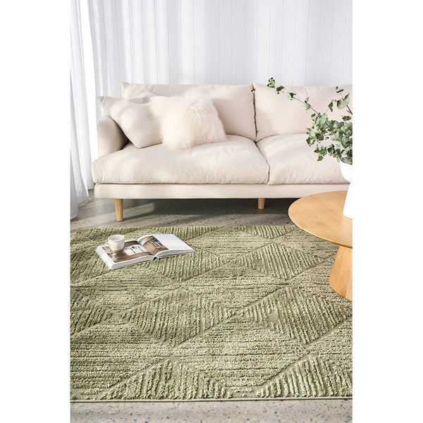 Emerald green modern rug with textured diamond pattern on light hardwood floor.